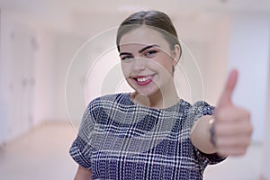 Business, education and sucess concept, Young female business woman standing and looking at camera with finger up