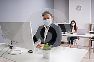 Business Employees In Office Wearing Medical Masks