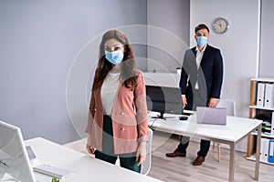 Business Employees In Office Wearing Medical Masks