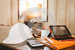 Business engineer working hard at his desk in apartment home building concept at construction site main office.