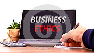 Business ethics symbol. Concept words Business ethics on beautiful black tablet. Beautiful white background. Calculator.