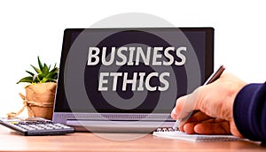 Business ethics symbol. Concept words Business ethics on beautiful black tablet. Beautiful white background. Calculator.