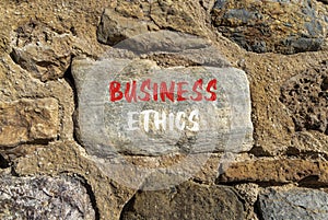 Business ethics symbol. Concept words Business ethics on beautiful grey stone. Beautiful brown stone wall background. Business