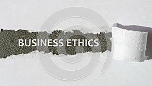 business ethics. words. text on gray paper on torn paper background