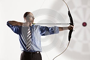 Business executive aiming at target. photo