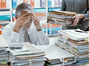 Business executive overloaded with work