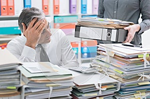 Business executive overloaded with work