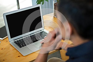 Business executive sitting at desk and using laptop