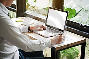 business executive using laptop with blank screen copy space at cafe