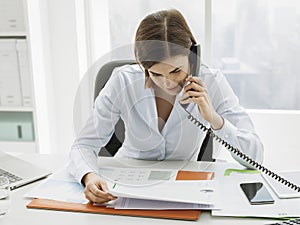 Business executive working in the office and making phone calls