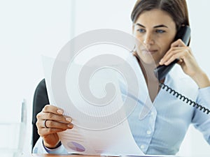 Business executive working in the office and making phone calls