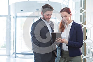 Business executives discussing over digital tablet