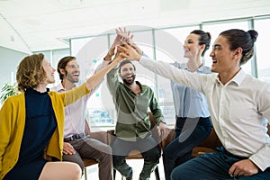 Business executives giving high five to each other