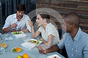 Business executives having meal on dining table