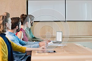 Business executives listening to a presentation in conference room