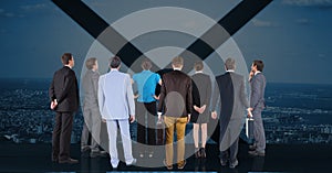 Business executives looking through window against cityscape in background