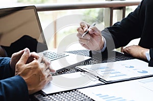 Business Executives meeting with data of sales performance at a modern outdoor workplace