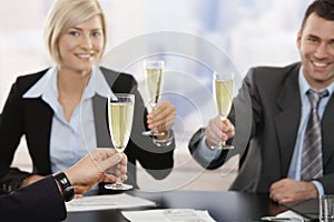 Business executives raising toast with champagne