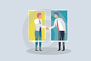 Business executives shake hands while communicating through mobile phone