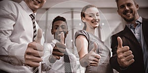 Business executives showing thumbs up sign