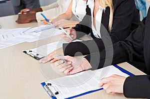 Business executives taking notes during a meeting