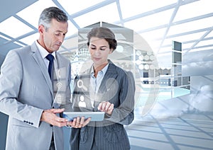 Business executives using digital tablet against digital interface in background