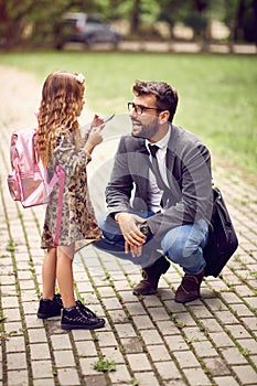 Business father taking child to primary school