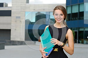 Business female with folders for papers in her hands