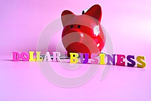 Business and finance concept. Dollar in the piggy bank and in the background. In the center is written - dollar and