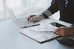 A business finance man is reviewing a company's financial documents prepared