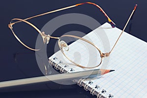 Business of finance notes blank paper with pencil and glasses