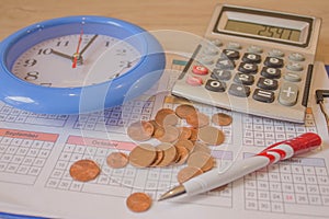 Business, finance, saving money, banking, loan, investment, taxes or accounting concept : Coins stack, calculator, pen a clock