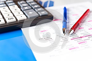 Business and financial background with data, pen and calculator. Bookkeeping background. photo