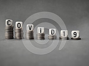 Business, Financial and Economic concept - COVID19 text on wooden blocks in vintage background. Stock photo