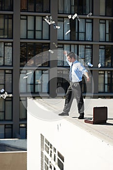 Business, financial freedom and money rain with a man in the city, throwing cash during a summer day. Finance, success