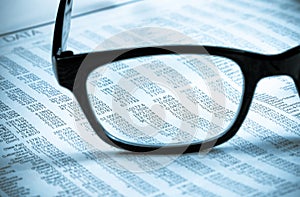 Business financial newspaper report see through glasses lens, workplace of the businessman