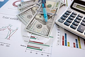 business and financial report with pen and calculator us dollar cash