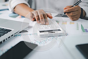 Business financing accounting banking concept. Businesswoman hand doing finances and calculate on desk about cost at home office.