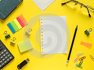 Business flat lay with copy space calculator, pencil, Notepad, coffee glasses on colorful yellow background