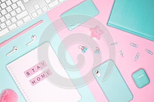 Business flat lay. Words `STAY HOME` made of pink wooden letters