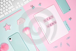 Business flat lay. Words `STAY HOME` made of pink wooden letters