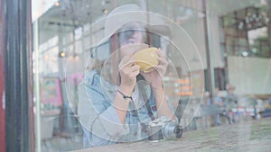 Business freelance asian woman drinking warm cup of green tea or coffee while sitting on table in cafe.