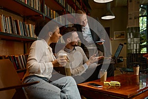 Business freelance team chatting during coffee break in office