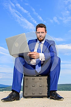 Business on fresh air. Businessman with laptop sit briefcase blue sky background. Laptop indispensable attribute modern photo