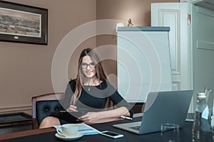 Business girl in glasses on workplace