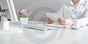 Business girl using tablet computer in office desk