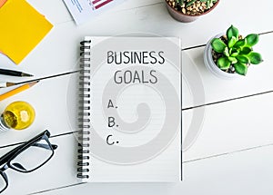 Business goals with notepad on office desk table with supplies