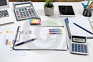 business graph documents and calculator, supplies on office desk table