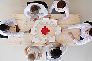 Business group assembling puzzle