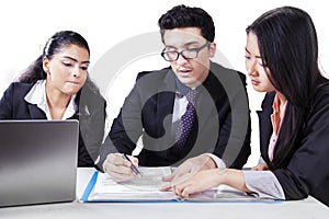 Business group discussing a document